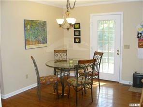 8009 Larkhaven Road Charlotte, NC 28216 - Photo 5 of 16 a view of a dining room with furniture window and wooden floor