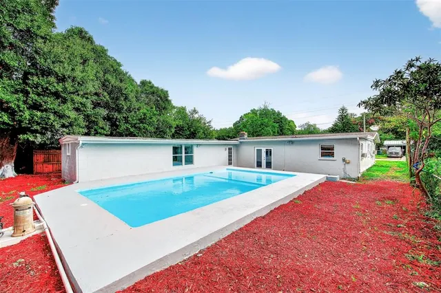 a view of a house with a backyard and a patio