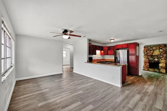 a view of a livingroom with wooden floor and a ceiling fan