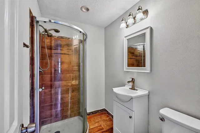 a bathroom with a toilet sink shower and mirror