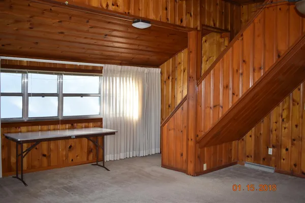 a bedroom with bed and a window