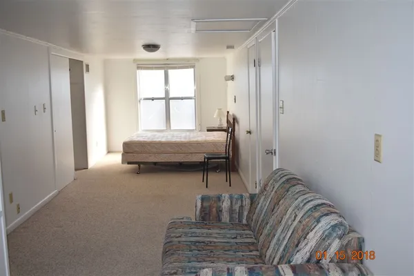 a bedroom with a bed and a chair