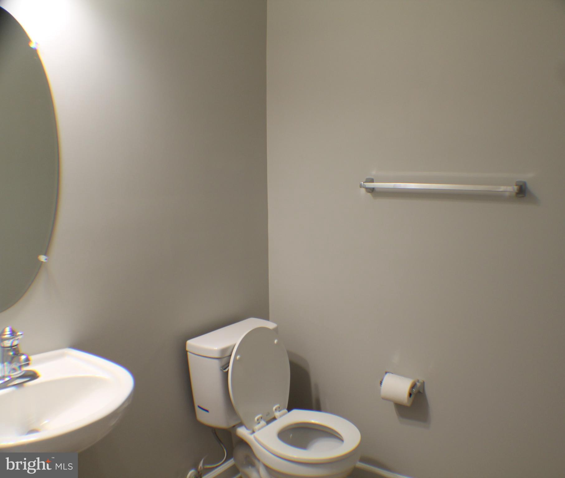 11837 Whitworth Cannon Lane Bristow, VA 20136 - Photo 11 of 63 a white toilet sitting next to a bathroom sink