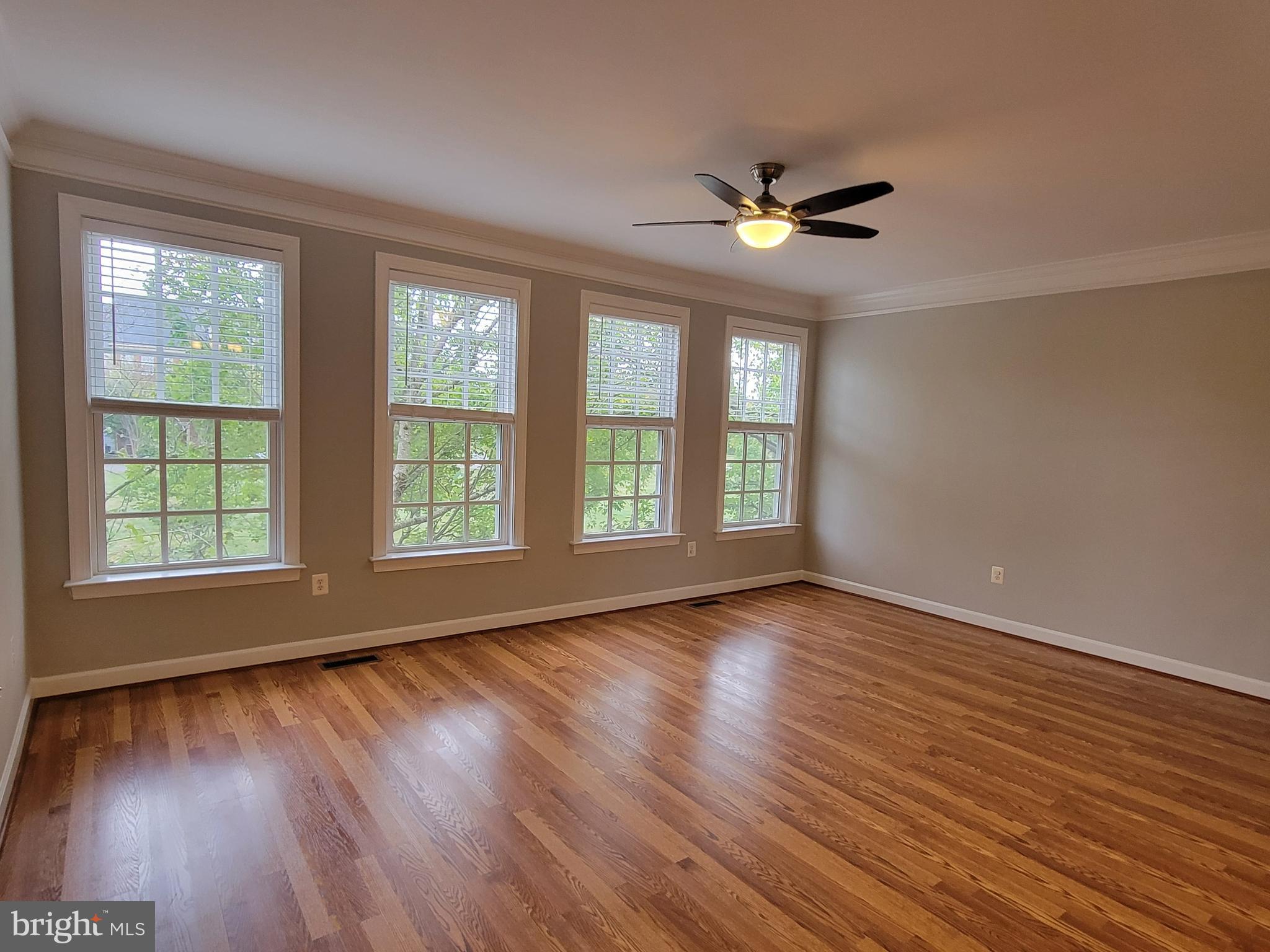11837 Whitworth Cannon Lane Bristow, VA 20136 - Photo 13 of 63 a view of an empty room with wooden floor and a window