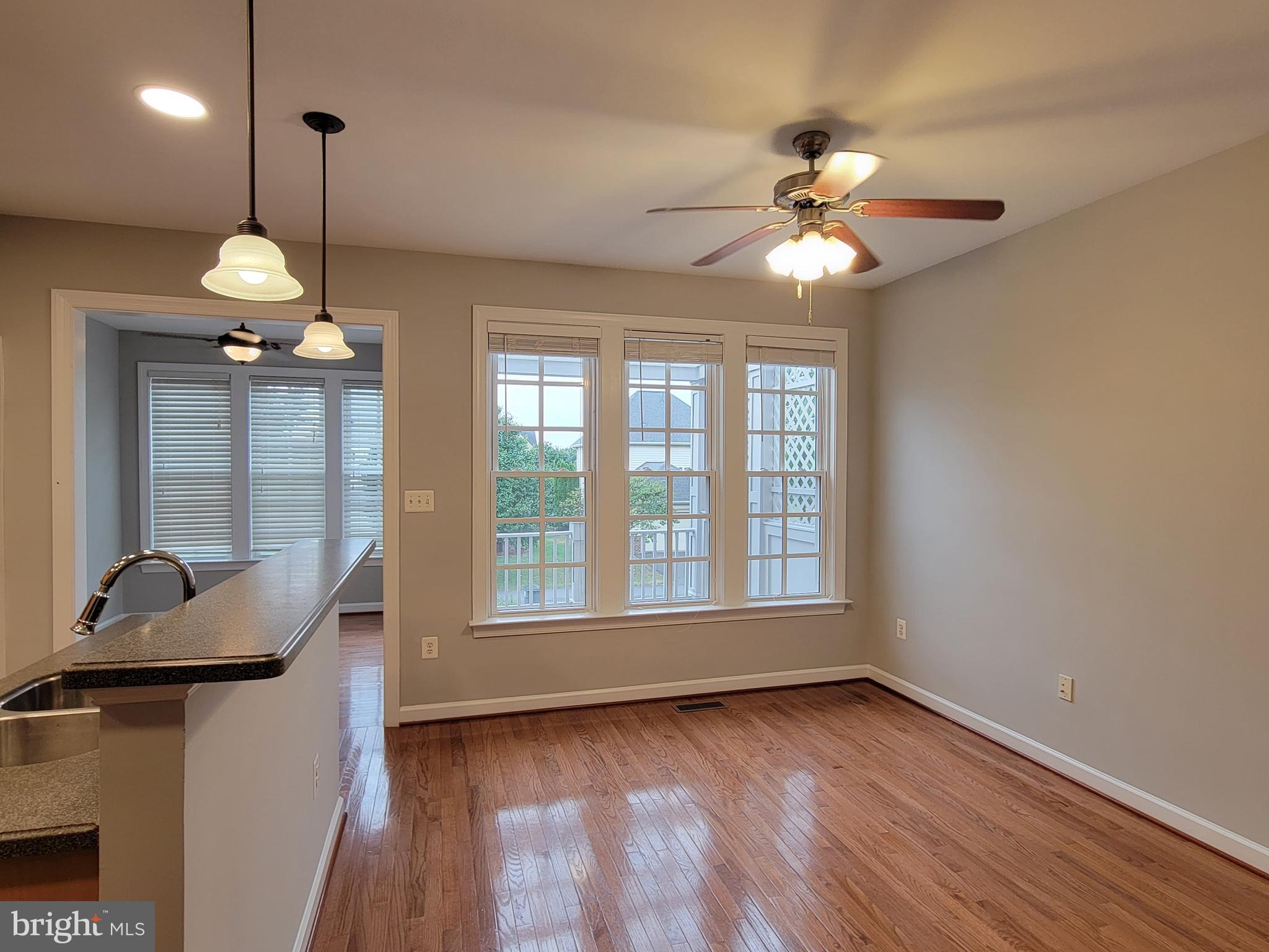 11837 Whitworth Cannon Lane Bristow, VA 20136 - Photo 18 of 63 a view of an empty room with a window and wooden floor