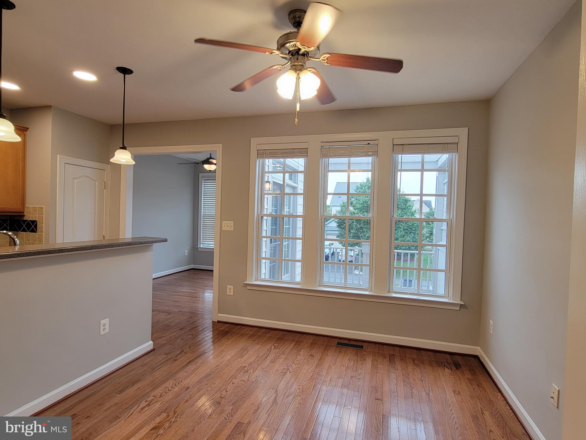 11837 Whitworth Cannon Lane Bristow, VA 20136 - Photo 19 of 63 a view of an empty room with a window and wooden floor
