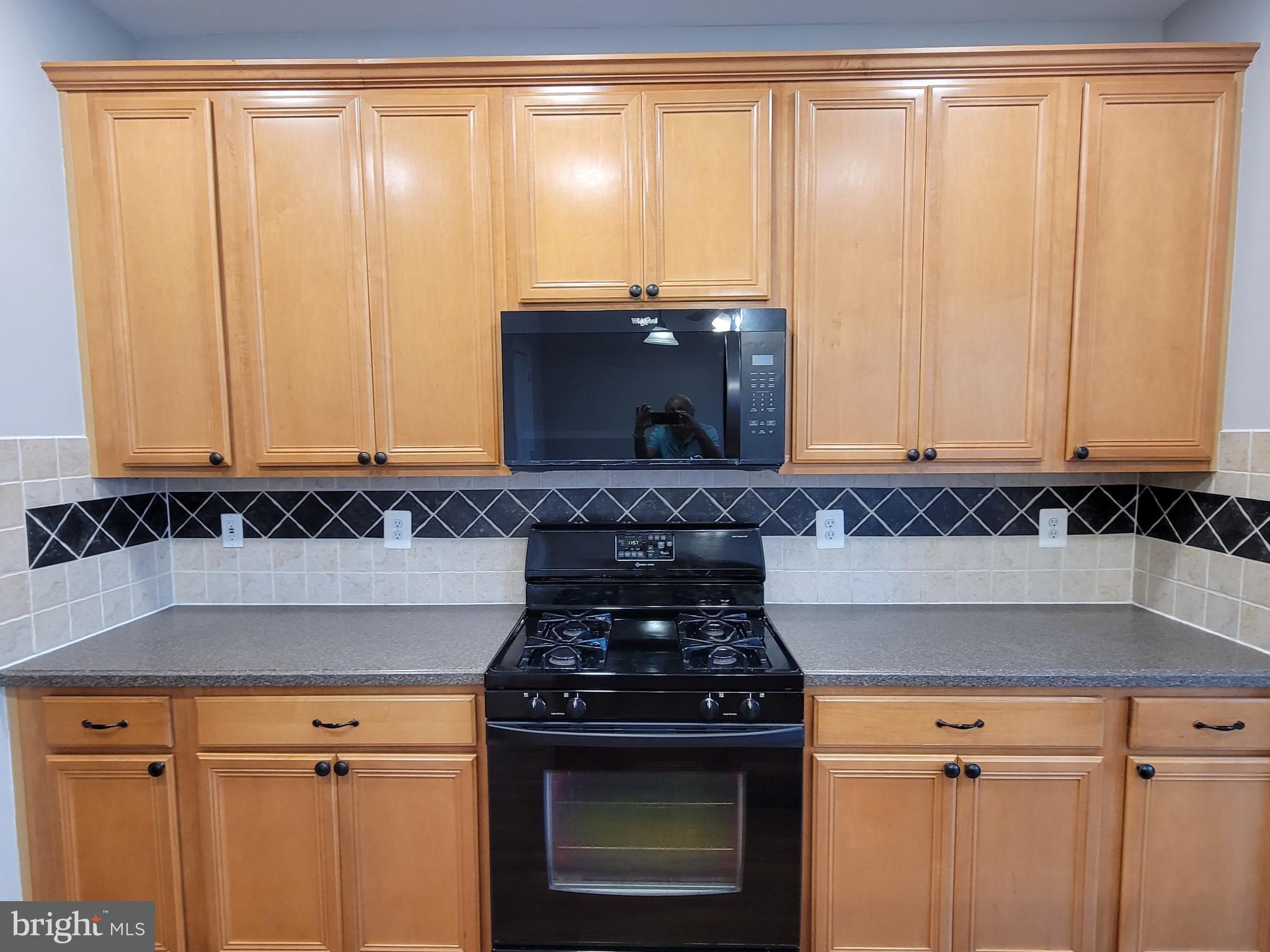 11837 Whitworth Cannon Lane Bristow, VA 20136 - Photo 23 of 63 a stove top oven sitting inside of a kitchen