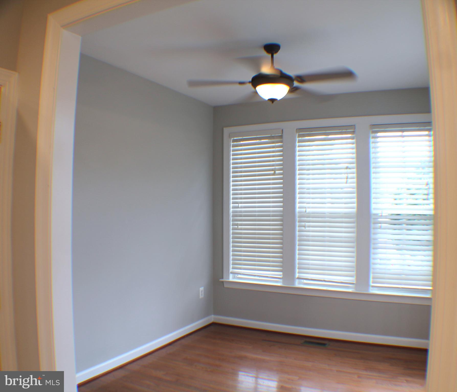 11837 Whitworth Cannon Lane Bristow, VA 20136 - Photo 28 of 63 a view of an empty room with wooden floor and a window