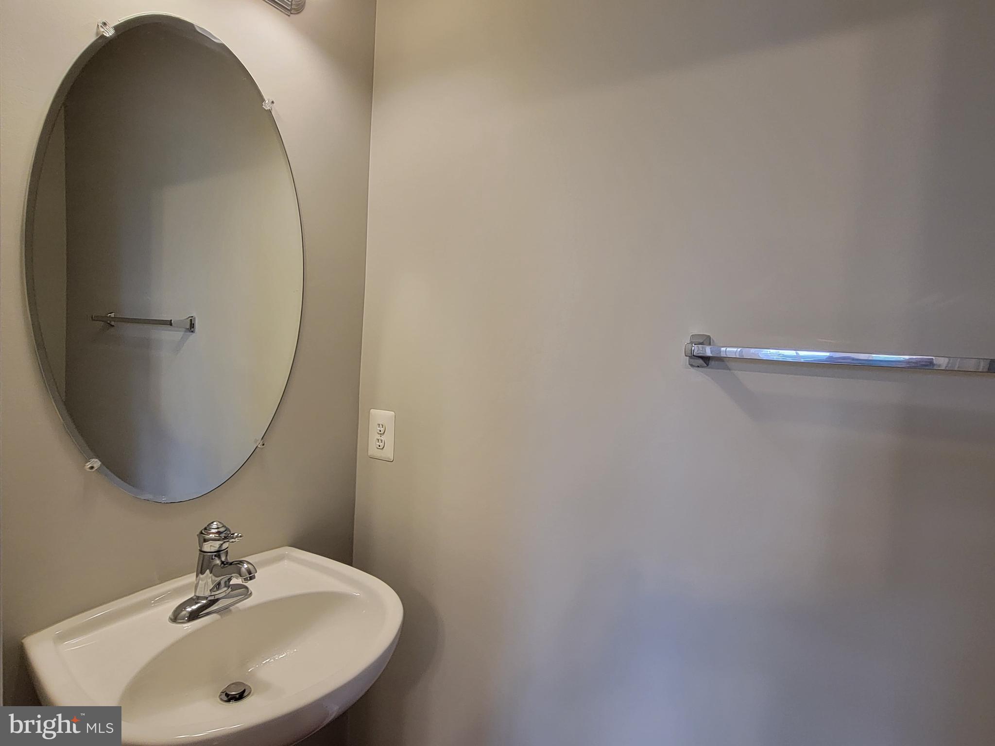 11837 Whitworth Cannon Lane Bristow, VA 20136 - Photo 29 of 63 a bathroom with a sink and mirror