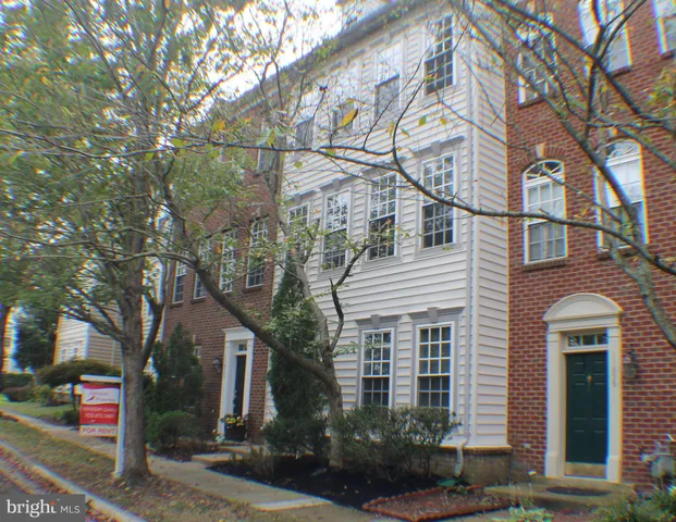a view of an empty room with wooden floor windows and stairs