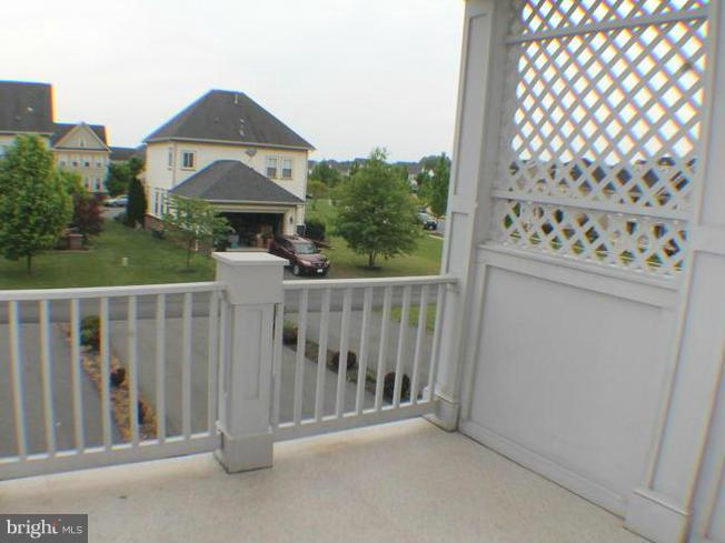 11837 Whitworth Cannon Lane Bristow, VA 20136 - Photo 31 of 63 a view of a white house in front of a yard