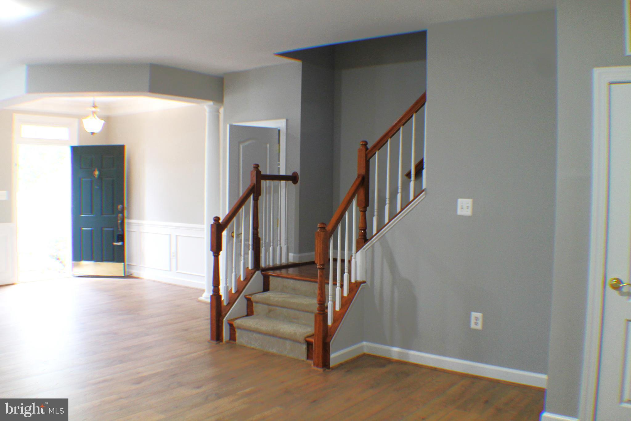 11837 Whitworth Cannon Lane Bristow, VA 20136 - Photo 4 of 63 a view of staircase with wooden floor and stairs