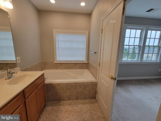 a bathroom with a bath tub with a shower