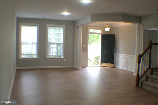 a view of an empty room with staircase