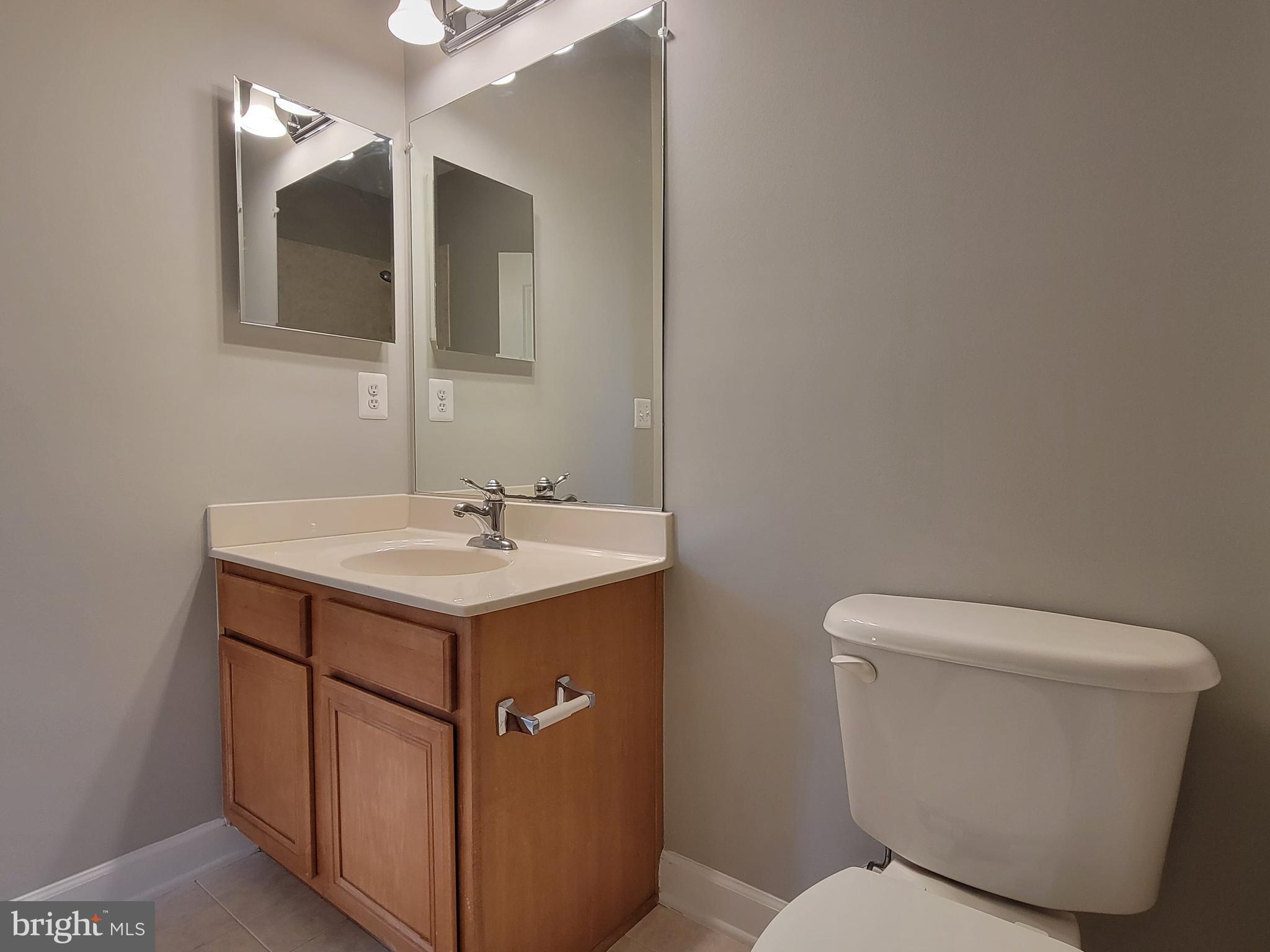 11837 Whitworth Cannon Lane Bristow, VA 20136 - Photo 54 of 63 a bathroom with a toilet sink and mirror