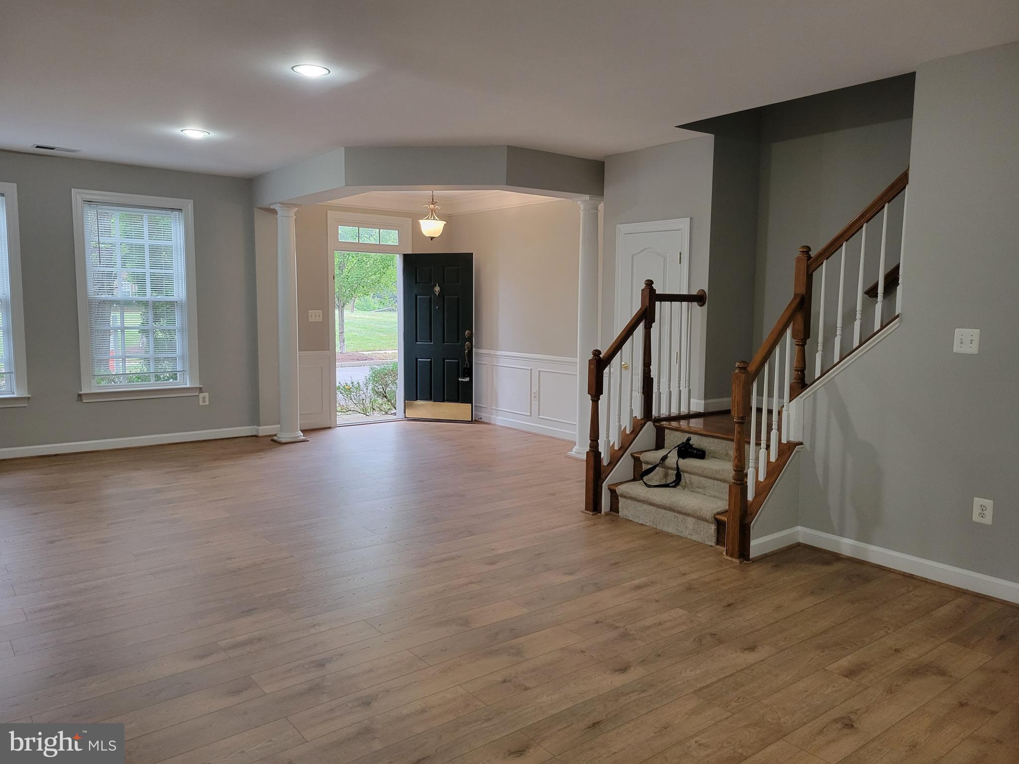 11837 Whitworth Cannon Lane Bristow, VA 20136 - Photo 6 of 63 a view of an empty room with wooden floor windows and stairs
