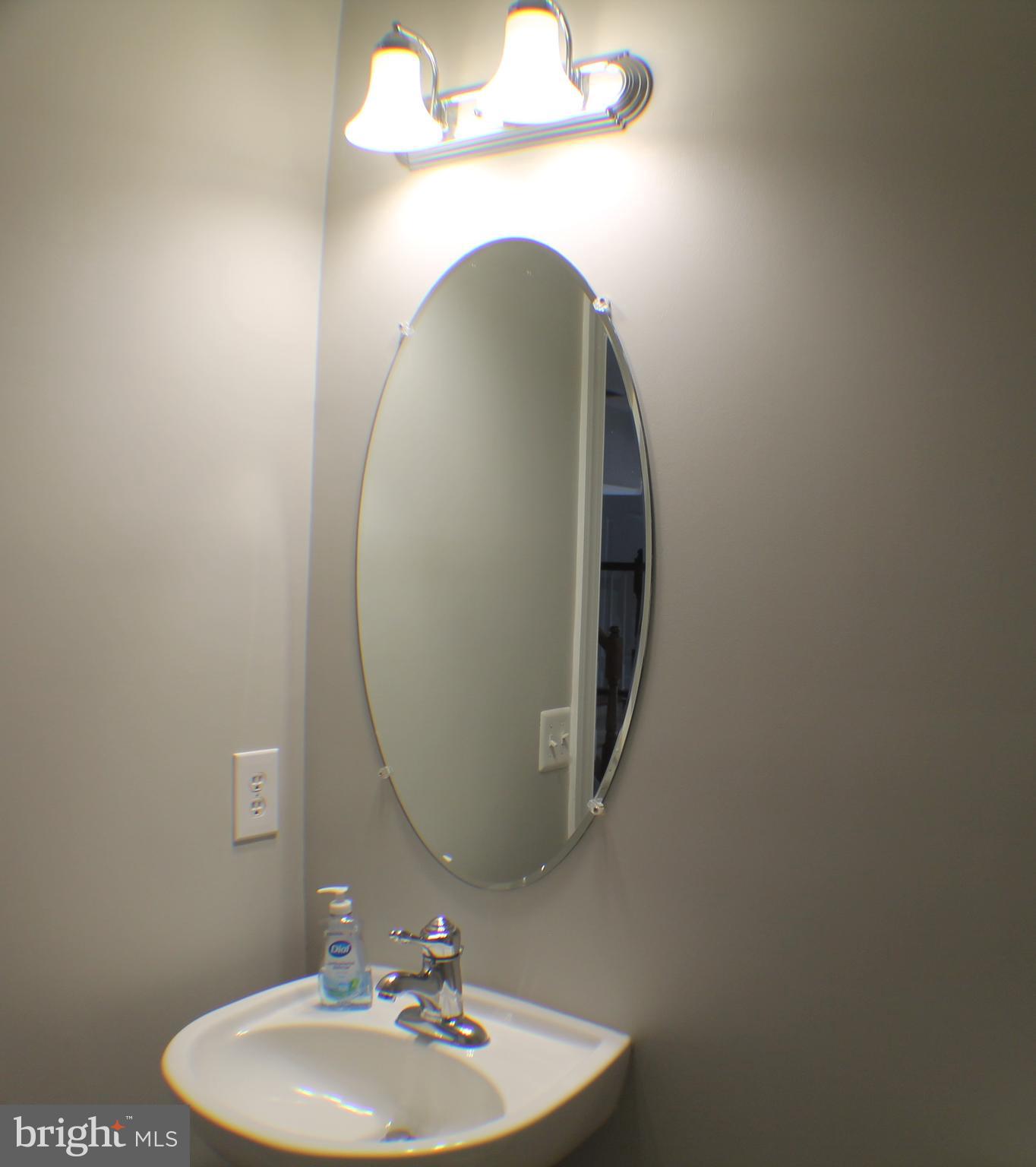11837 Whitworth Cannon Lane Bristow, VA 20136 - Photo 10 of 63 a bathroom with a sink and mirror