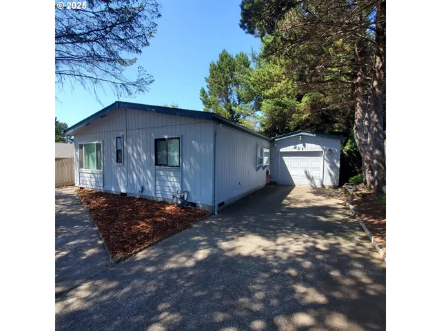 a view of a small house with a yard