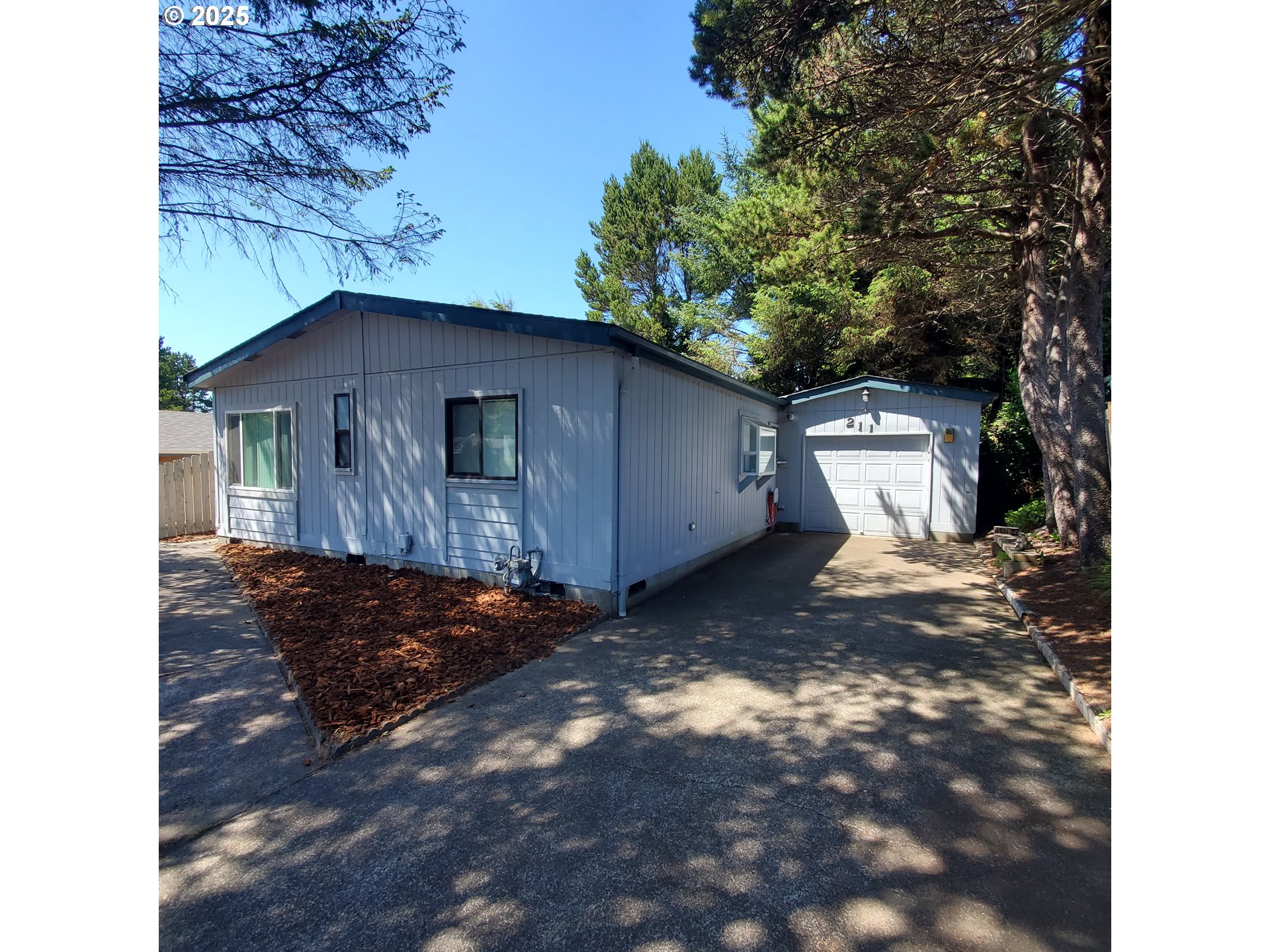 a view of a small house with a yard