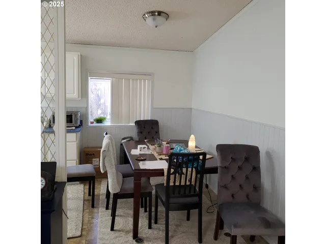 a view of a dining room with furniture and window