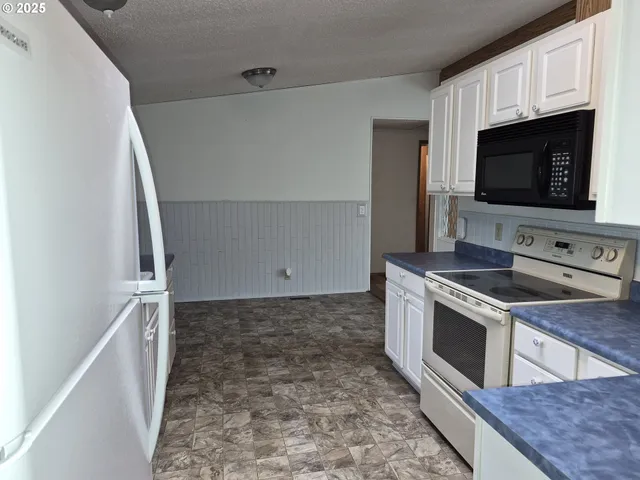 a view of a kitchen with microwave and stove