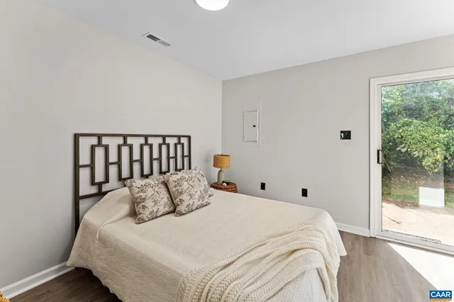 a large bed sitting in a bedroom next to a window