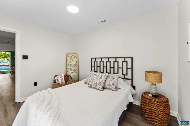 a bedroom with a bed and a lamp