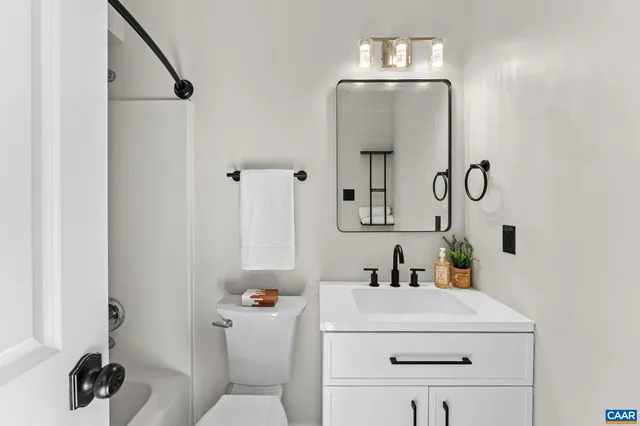 a bathroom with a sink vanity and toilet