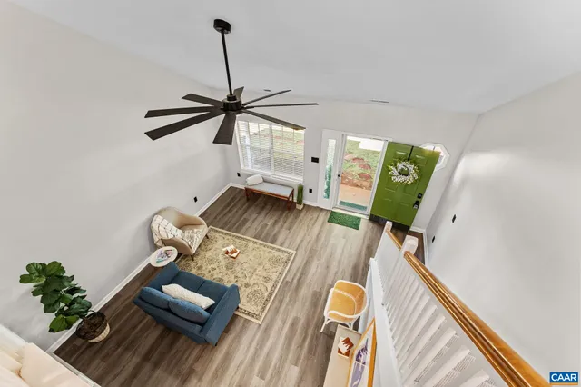 a living room with furniture and a wooden floor