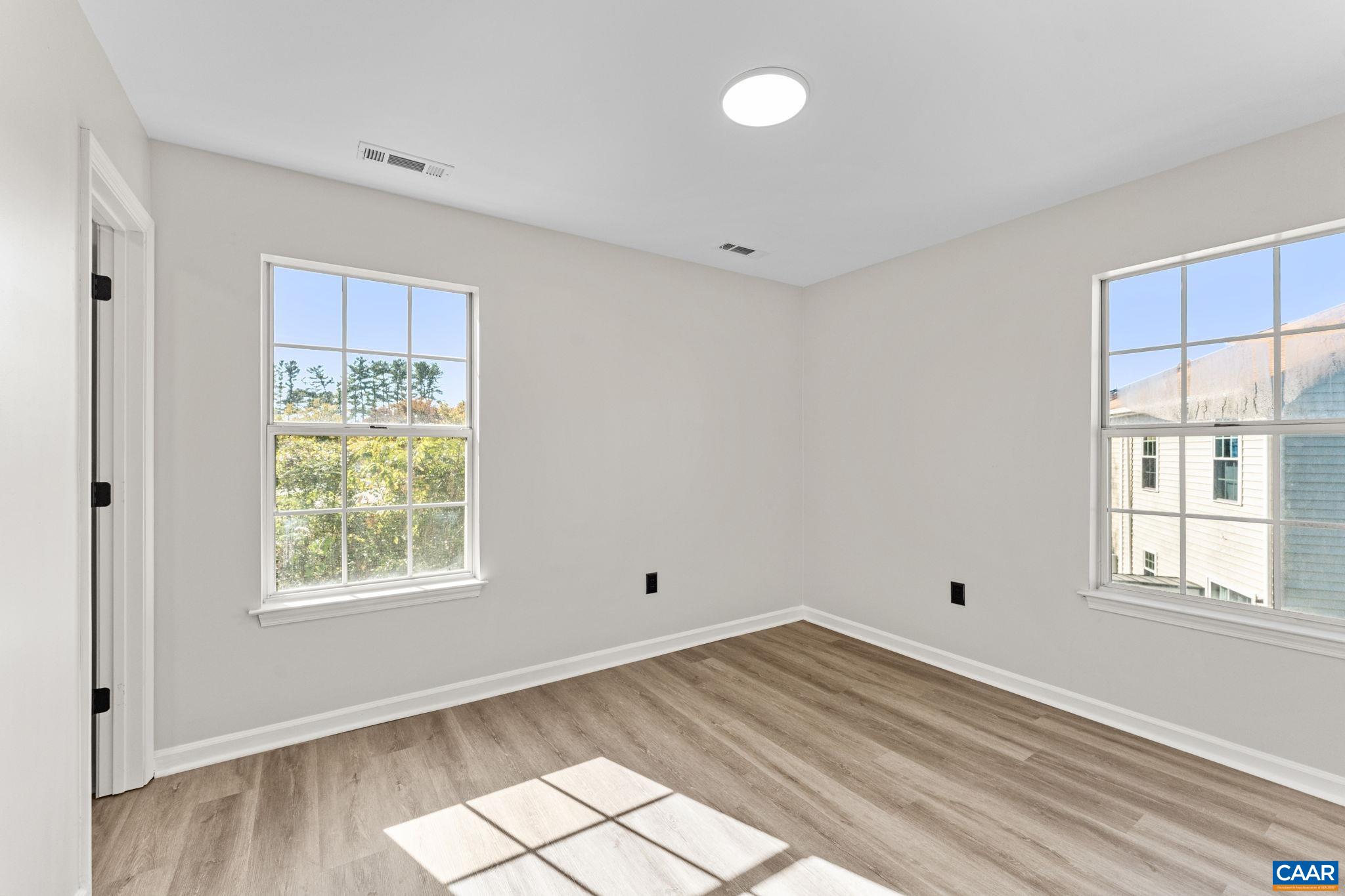 403 Riverside Avenue Charlottesville, VA 22902 - Photo 17 of 27 a view of empty room with wooden floor and fan