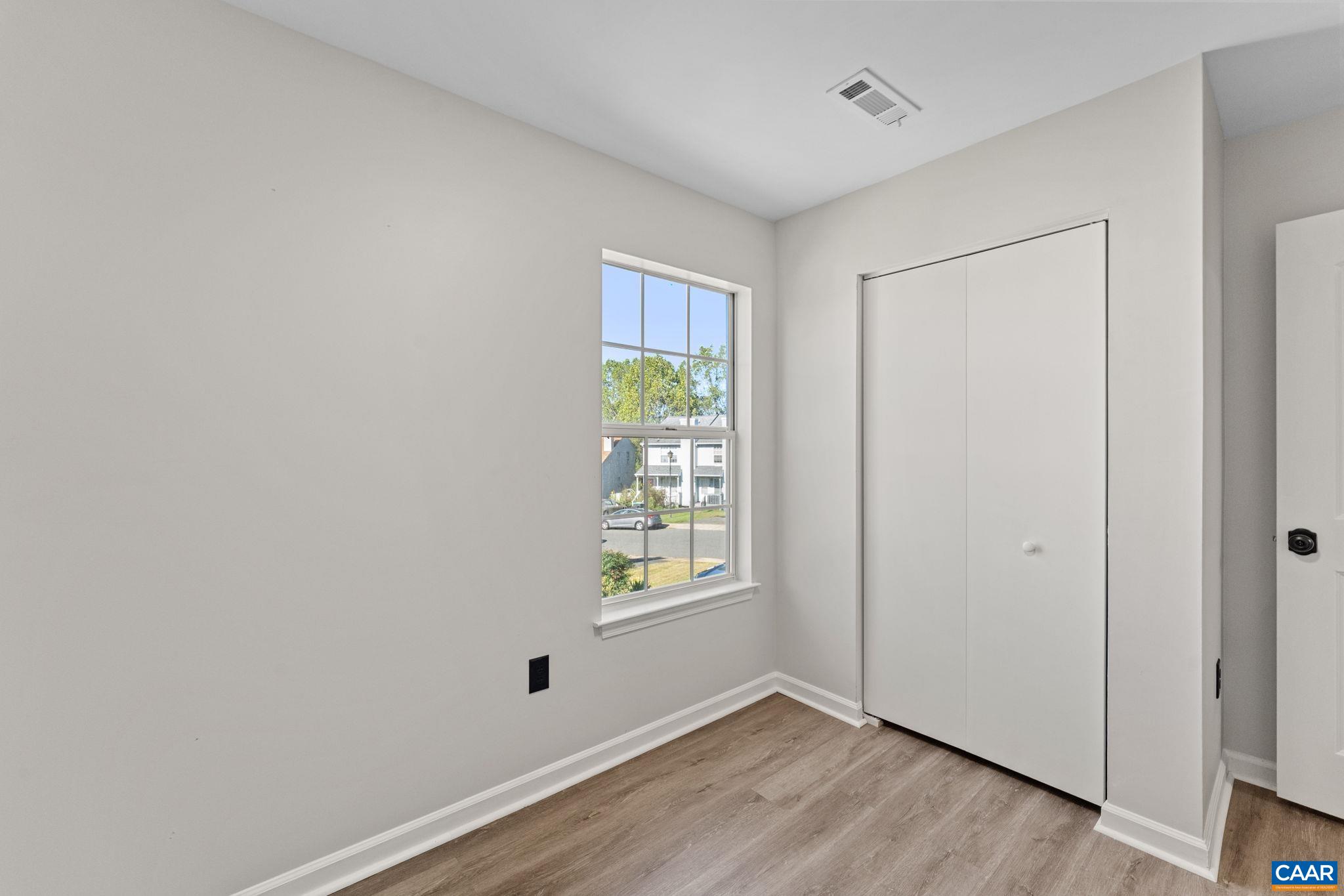 403 Riverside Avenue Charlottesville, VA 22902 - Photo 19 of 27 a view of an empty room with wooden floor and a window
