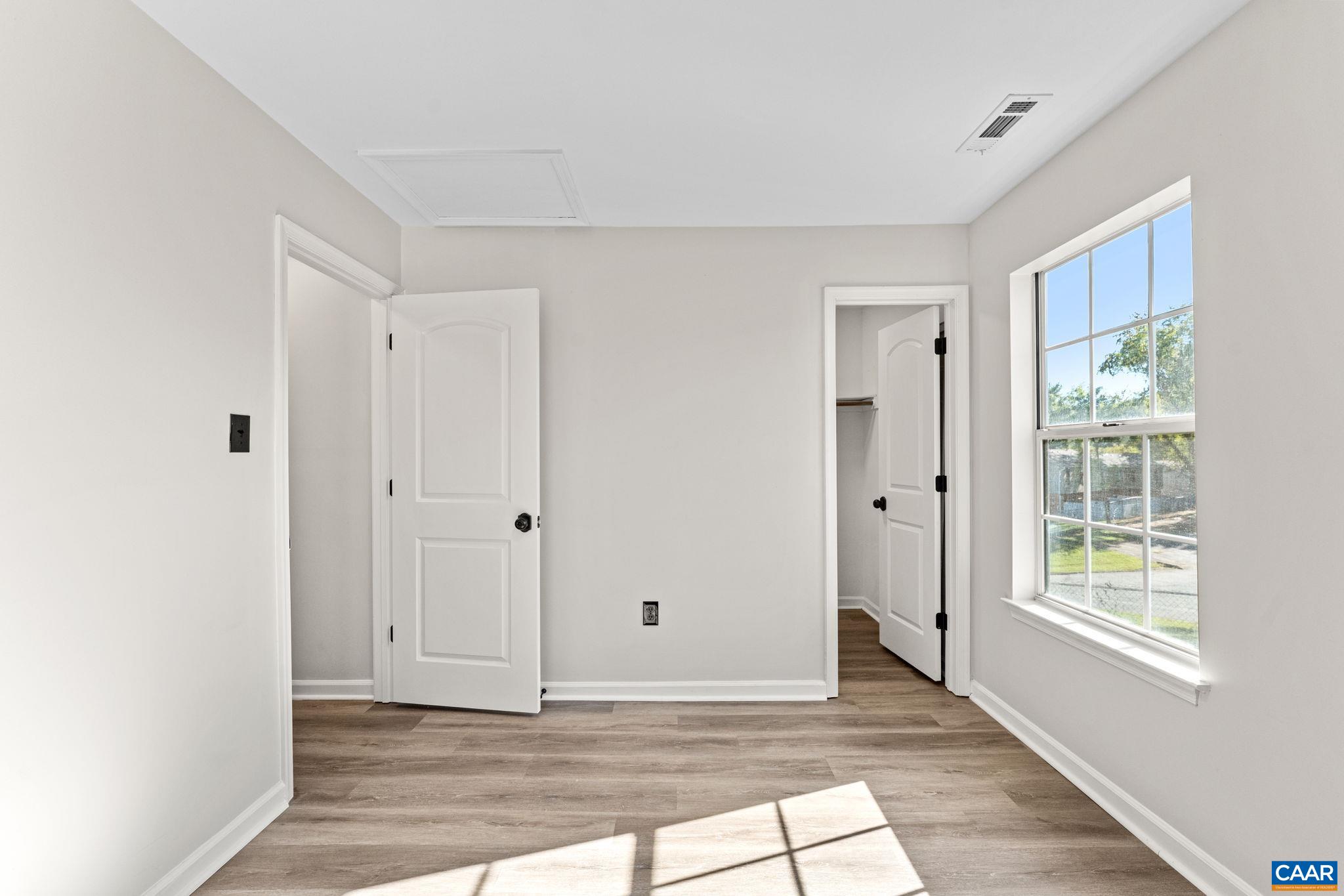403 Riverside Avenue Charlottesville, VA 22902 - Photo 22 of 27 a view of an empty room with wooden floor and a window