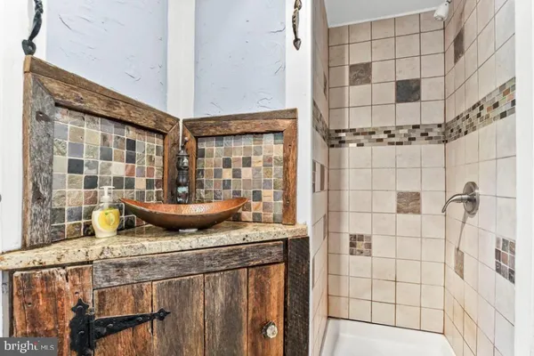 a view of a bathroom with a shower and a sink