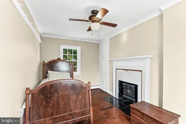 a bedroom with a bed and a fireplace