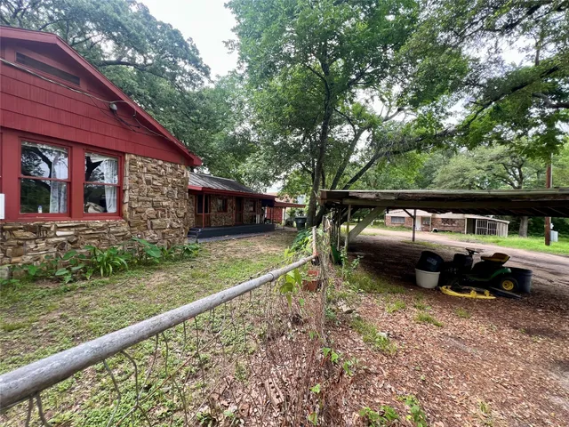 a view of a house with a yard and sitting area