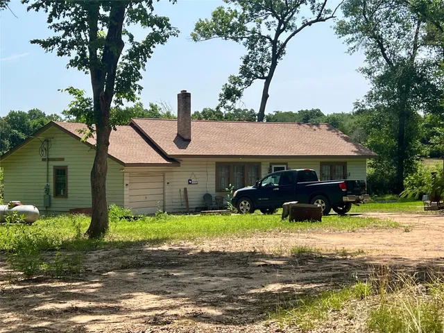 a front view of house with yard and trees