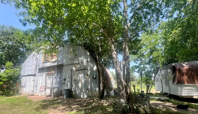 a backyard of a house with barbeque oven