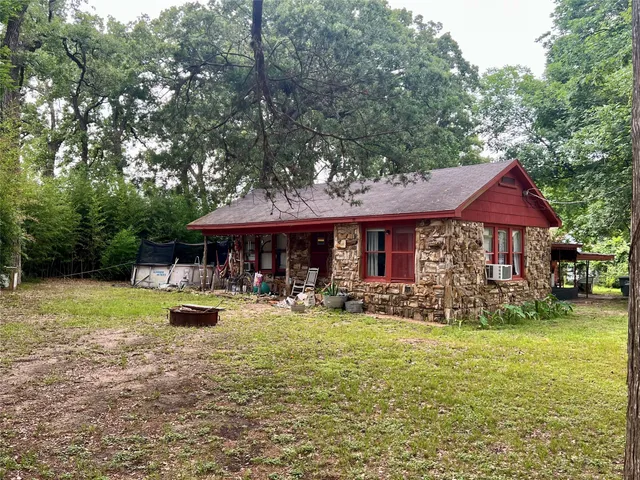 a backyard of a house with yard and outdoor seating
