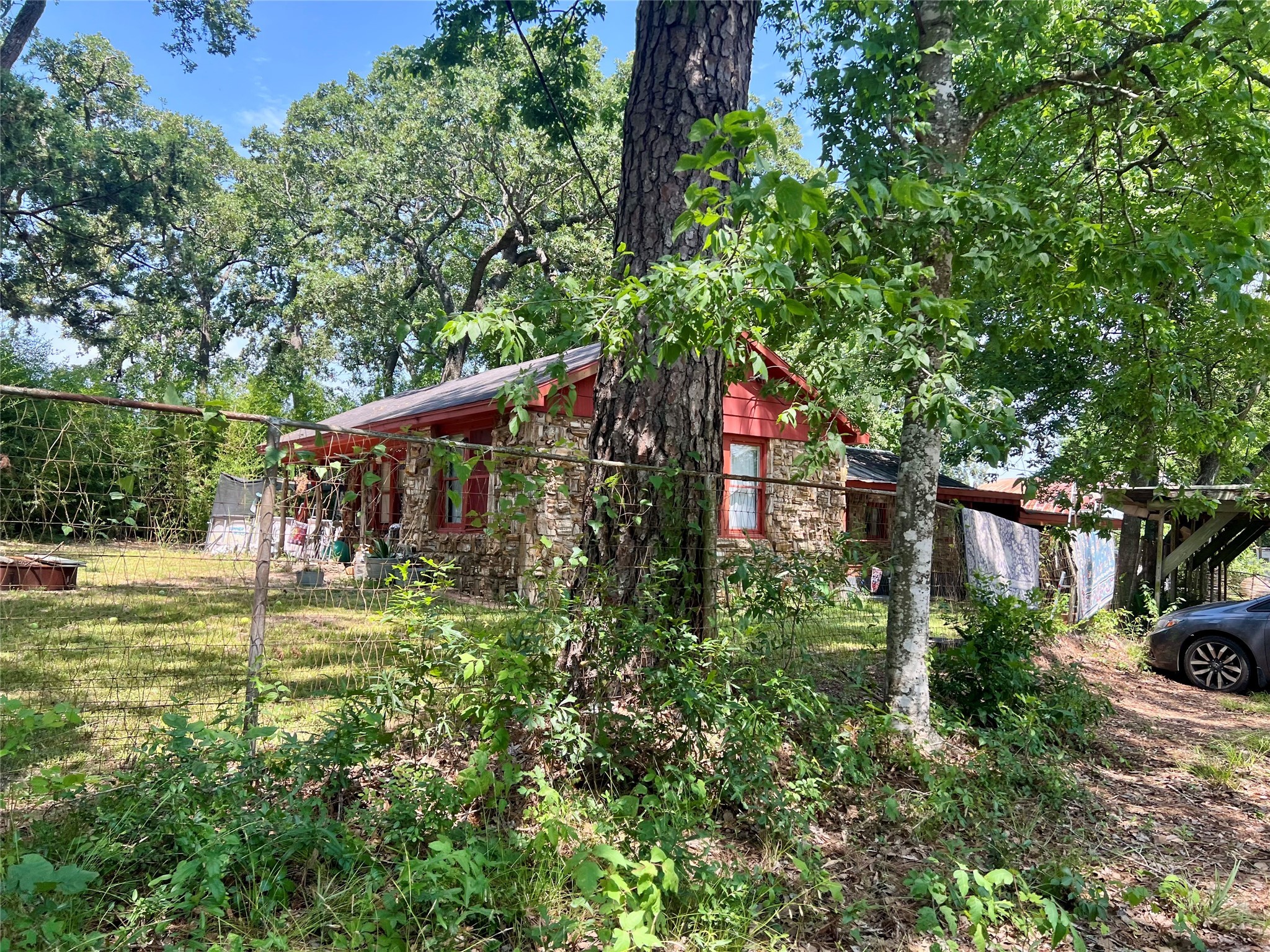 22606 Farm To Market 359 Hempstead, TX 77445 - Photo 9 of 26 a backyard of a house with lots of green space and fountain