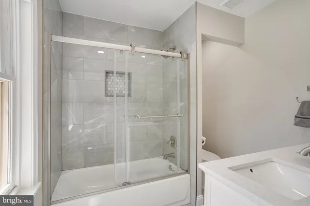 a bathroom with a bathtub and a shower