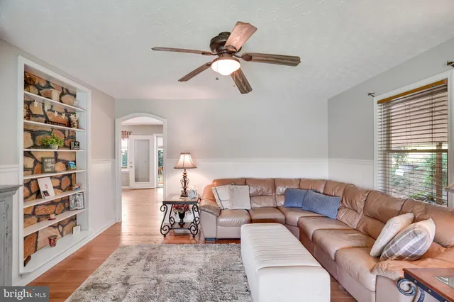 a living room with furniture and a book shelf