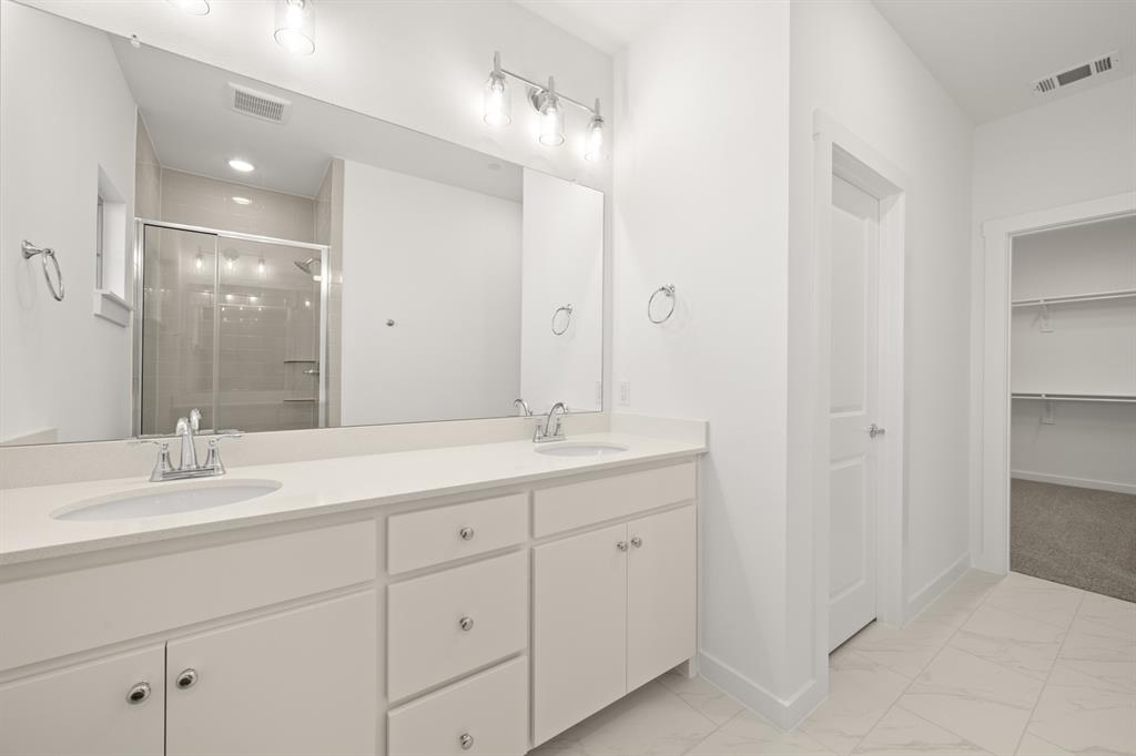 4619 Hawks Trail Oak Point, TX 75068 - Photo 31 of 40 a bathroom with double sink and a mirror