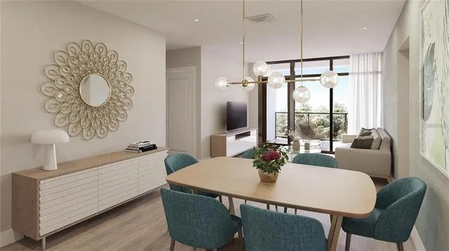 a view of a dining room with furniture window and wooden floor