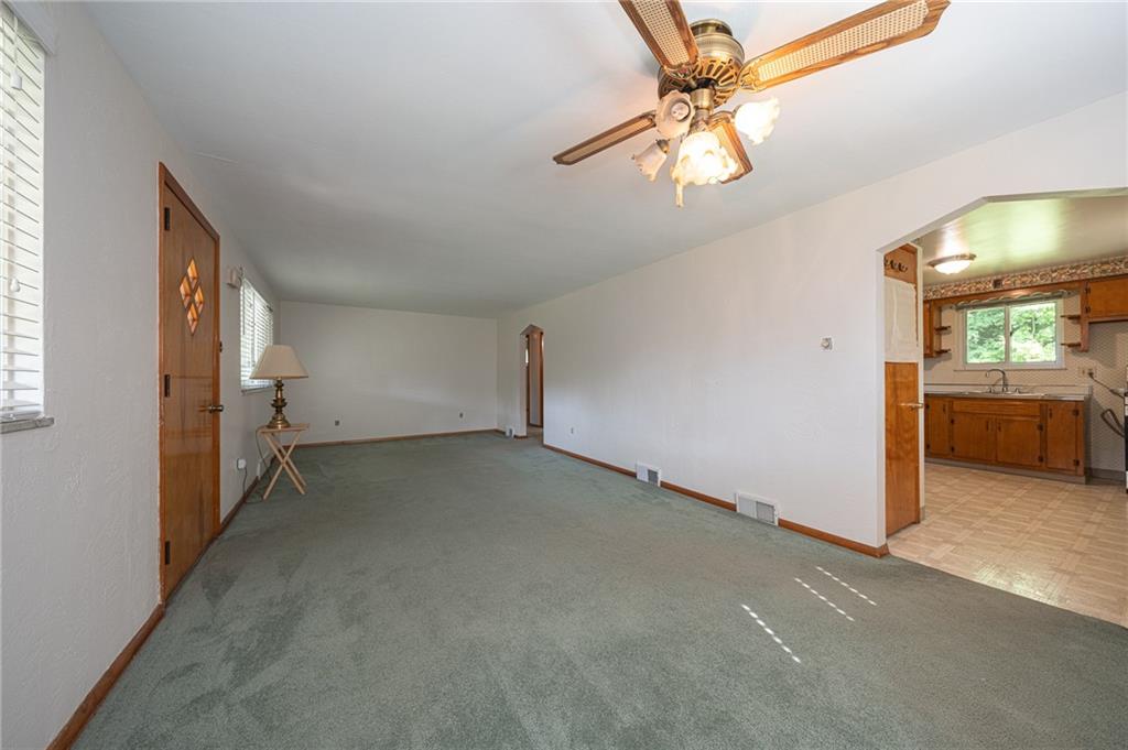 244 Herbst Road Coraopolis, PA 15108 - Photo 14 of 35 26x12 Living room/dining room combination with hardwood flooring under the wall to wall carpeting.