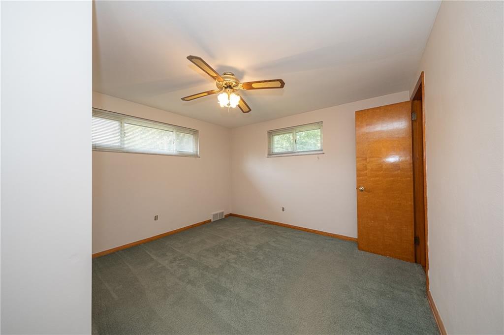 244 Herbst Road Coraopolis, PA 15108 - Photo 18 of 35 Primary bedroom features a ceiling fan and hardwood flooring under the carpet.