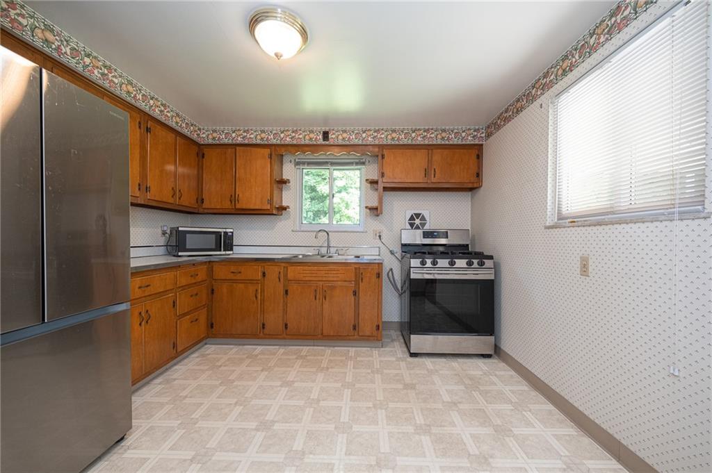 244 Herbst Road Coraopolis, PA 15108 - Photo 9 of 35 Spacious 14x11 kitchen with gas stove, stainless refrigerator and microwave.