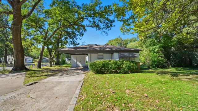 a view of a house with a tree in a yard