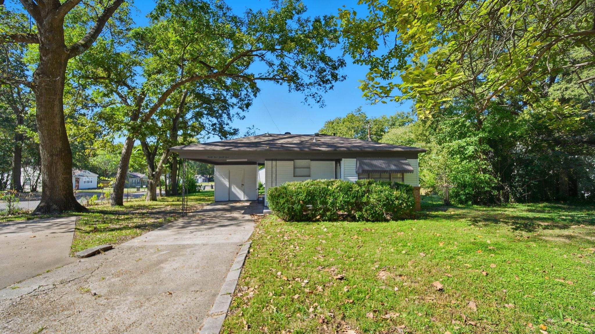 a view of a house with a tree in a yard