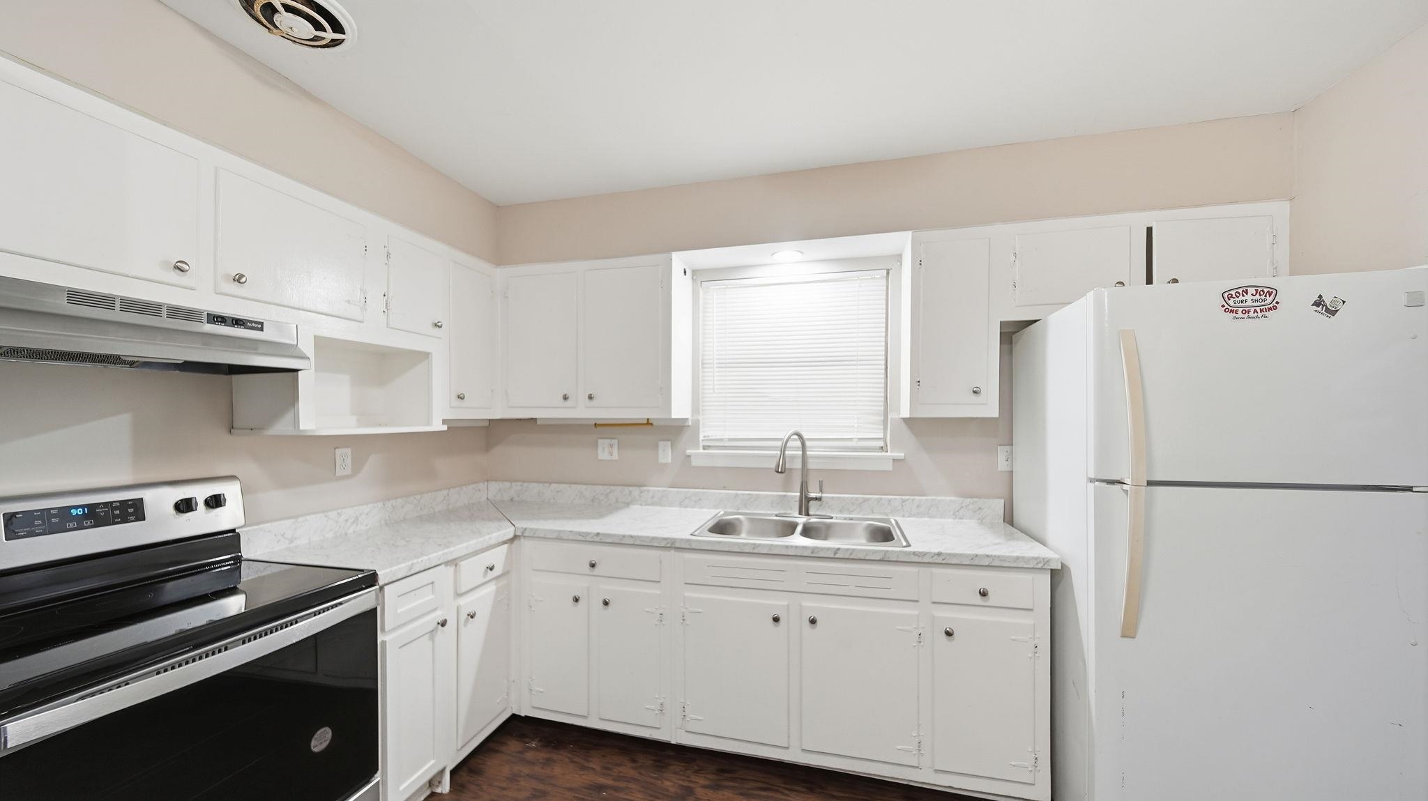 3531 Randolph Street Memphis, TN 38127 - Photo 12 of 32 a kitchen with a refrigerator sink stove and cabinets