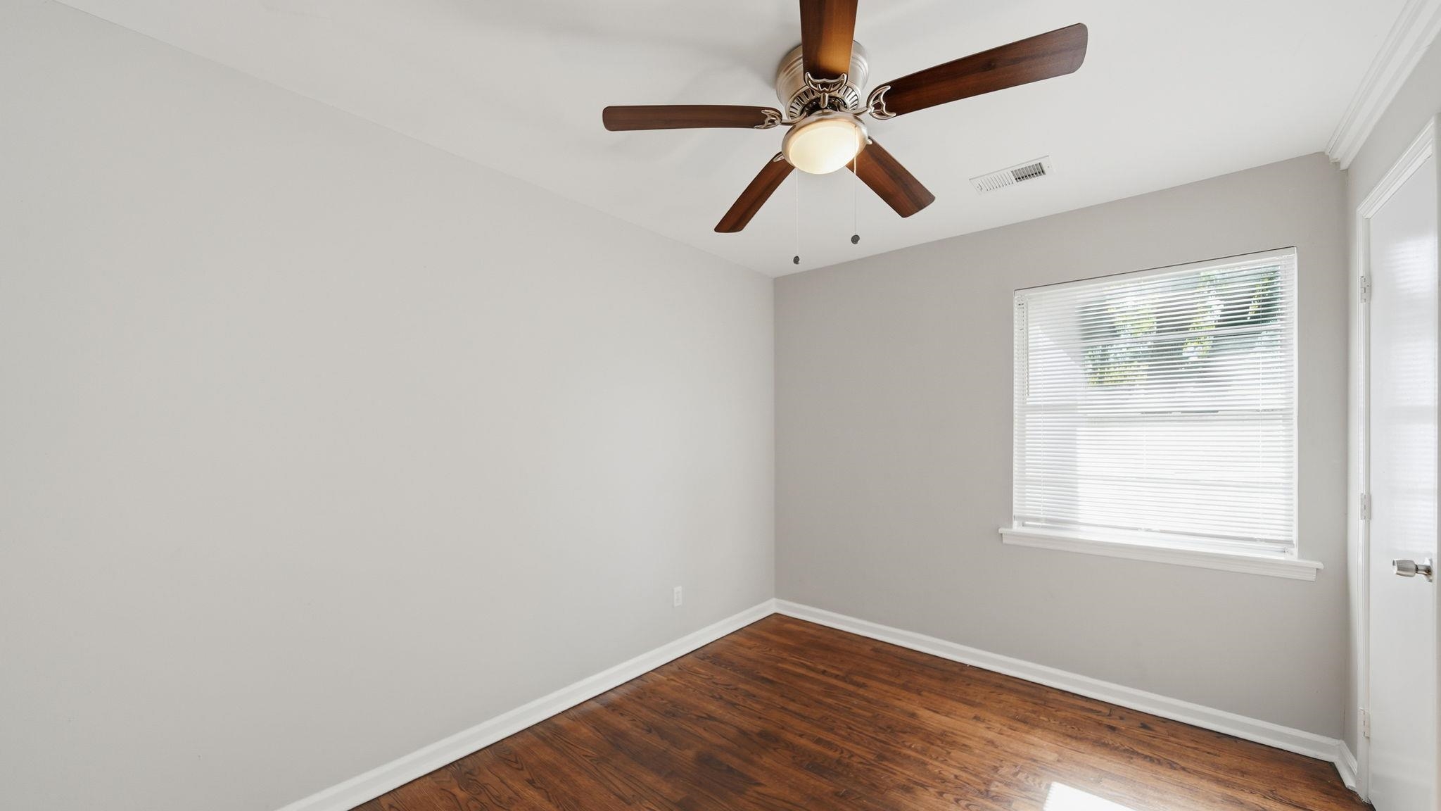 3531 Randolph Street Memphis, TN 38127 - Photo 18 of 32 an empty room with wooden floor fan and windows